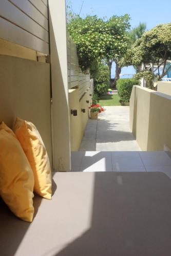 a yellow pillow sitting on the side of a building at Effi Apartments in Plataniás