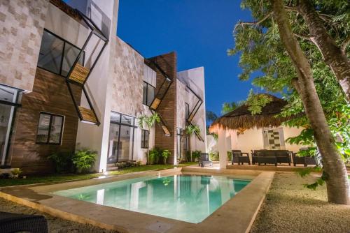 an exterior view of a house with a swimming pool at Tannah Luxury Rentals in Mérida