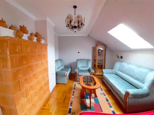 a living room with a couch and chairs and a table at Mátra Wellness Vendégház in Parádsasvár
