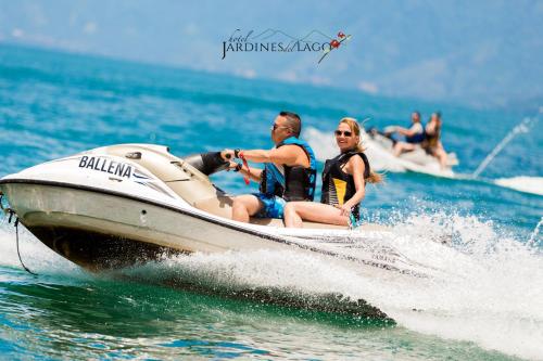 a group of people riding on a speed boat in the water at Hotel y Centro de Convenciones Jardines del Lago in Panajachel