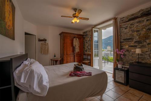 a bedroom with a bed and a ceiling fan at Locanda La Pergola in Bellagio
