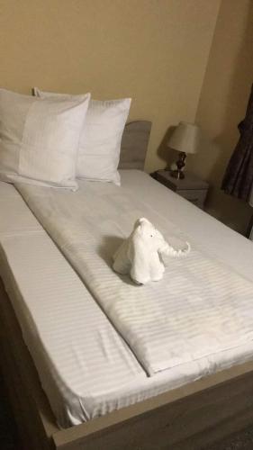a stuffed elephant sitting on top of a bed at Pensiunea Mirela Peștera Urșilor in Chişcău