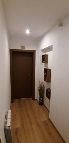 a room with a door and a hard wood floor at Guest House Raffe in Dobrinishte
