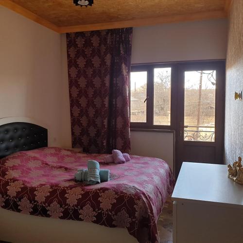 a bedroom with a bed and a window at Tatev Shinuhayr Hotel' in Shinuhayr