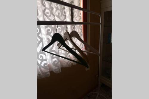 a bedroom with a curtain and a bed in a window at Attico Incerpi, terrazza sui tetti di Montecatini Terme in Montecatini Terme