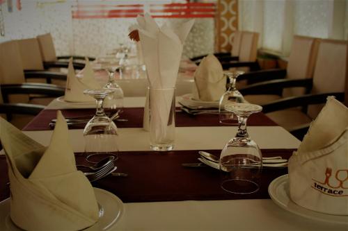 a table with plates and wine glasses on top of it at Hotel Blue Bird in Dhaka