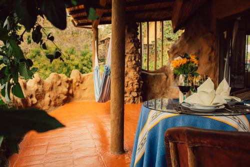 a table with a blue table cloth and flowers on it at Hotel Valle Místico in Tepoztlán