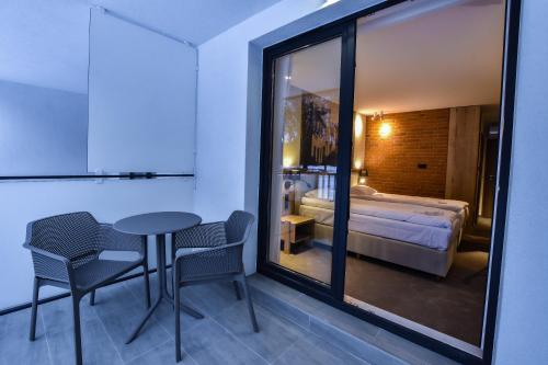 a room with a table and chairs and a bed at Strzelnica Hotel i Restauracja in Starogard Gdański