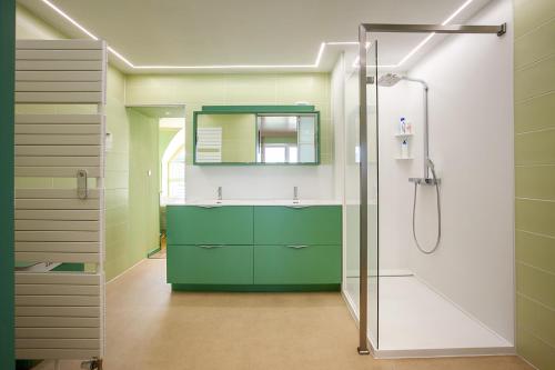 a bathroom with a green vanity and a shower at Thai Time Wellness in Antwerp