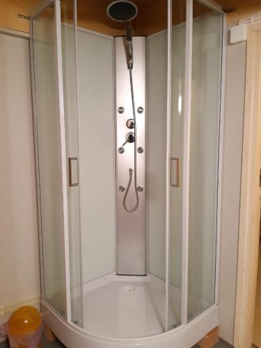 a shower with a glass enclosure in a bathroom at Yö Kotikoivun rauhassa in Kankaanpää