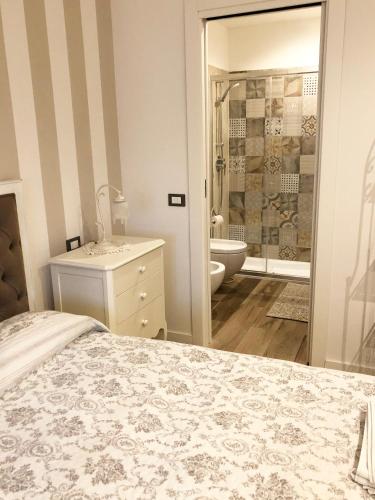 a bedroom with a bed and a bathroom with a shower at La Rosa Bianca in Rozzano