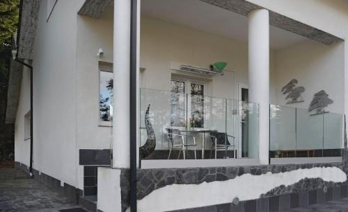 a house with glass windows on the side of it at The Retreat Tranquil Countryside Apartment in Larkhall