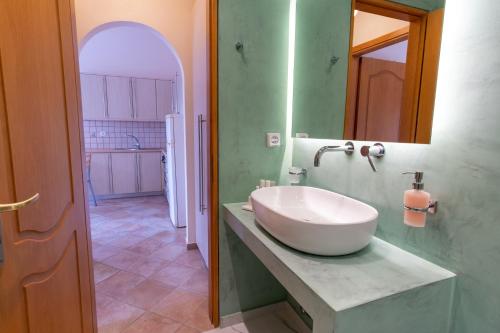 a bathroom with a large white sink on a counter at Tinos Koralli in Tinos Town