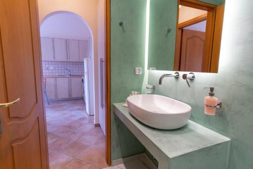 a bathroom with a large white sink on a counter at Tinos Koralli in Tinos