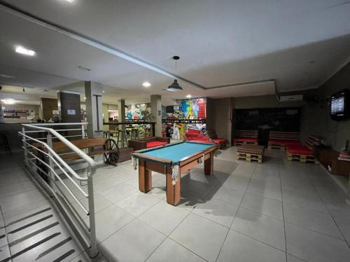 a living room with a ping pong table in it at Lakehouse 24hs Hostel Lagoa Conceicāo in Florianópolis