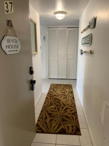 a hallway with a door leading to a house at Sea Club Condo #37 in Clearwater Beach