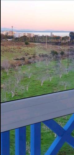 a view of a field of grass from a window at Bright apartment in Marina Smir, sea view and shared pool in Marina Smir