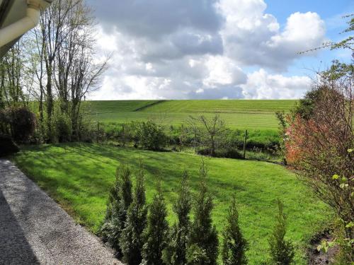 a field of green grass with a road at Beachbungalow Park Iselmar 39 aan Ijsselmeer bungalow 26 in Lemmer