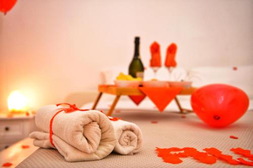 a towel laying on a table with a bottle of wine at Trullo Suite in Cisternino