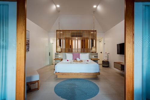 a bedroom with a large bed and a large window at Escape at Nonsuch Bay Antigua - All Inclusive - Adults Only in Gaynors