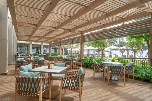 a dining area with tables and chairs at The Secret Con Dao in Con Dao