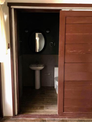 a bathroom with a sink and a mirror at PAYAG SUITES in General Luna
