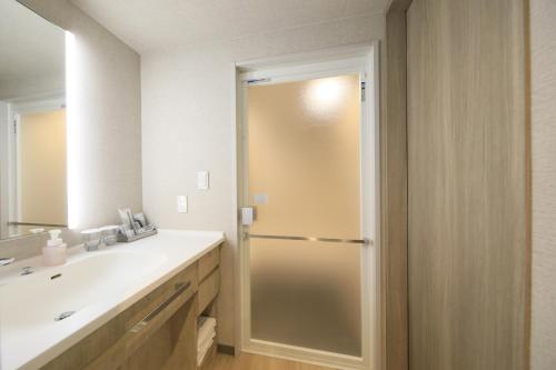 a bathroom with a shower and a sink at Richmond Hotel Morioka Ekimae in Morioka