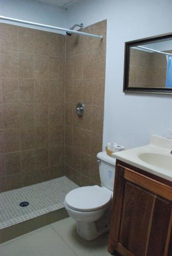 a bathroom with a toilet and a sink at Hotel Coastalbay 2 & Golf Cart Rental in San Pedro