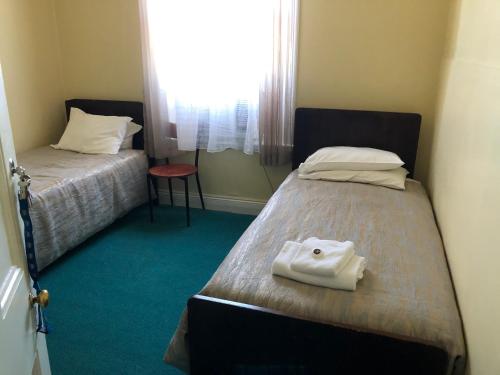 a small room with two beds and a window at Commercial Hotel Morgan in Morgan