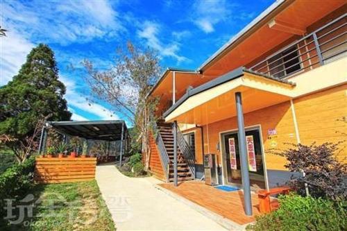 an orange house with a porch at Tianen Farm in Hualing