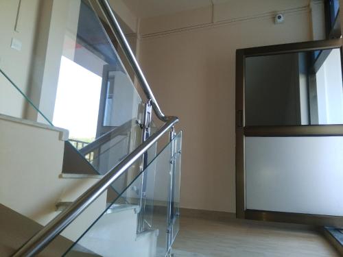 a glass staircase in a building with a window at Sulawado Resort in Cherrapunji