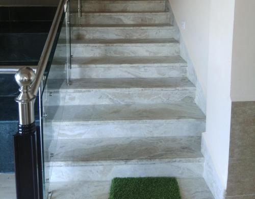 a set of stairs with a green rug at Sulawado Resort in Cherrapunji