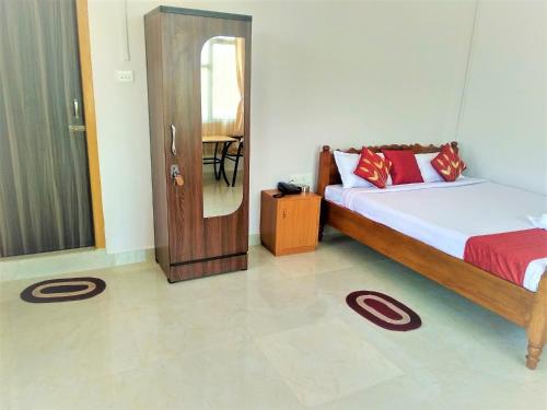 a bedroom with a bed and a door with a mirror at Sulawado Resort in Cherrapunji