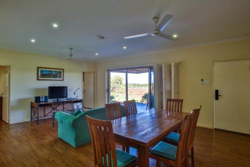a living room filled with furniture and a table at Kimberley Hotel in Halls Creek