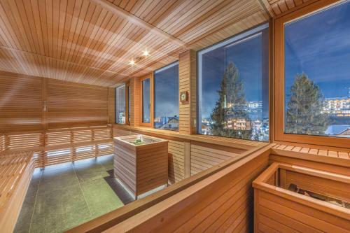 an empty sauna with a view of the city at Piz Galin Grand Hotel Family & Wellness in Andalo