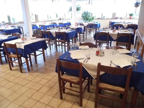 a dining room with tables and chairs with blue table cloth at Guesthouse Pri Štefanu in Most na Soči