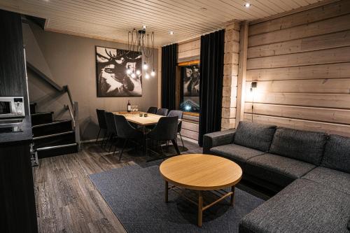 a living room with a couch and a table at Levi Black Apartments in Levi