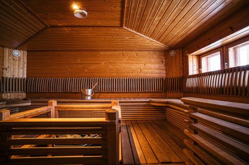 an empty sauna with wooden walls and wooden benches at Levi Black Apartments in Levi