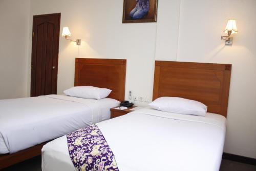 Кровать или кровати в номере PIA Hotel Pangkalpinang
