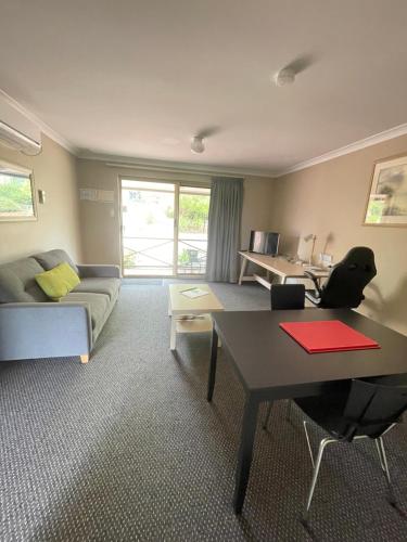 a living room with a couch and a table at Studio32 in Albany