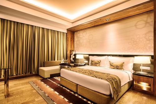 a hotel room with a bed and a large window at Crowne Plaza New Delhi Rohini by IHG in New Delhi
