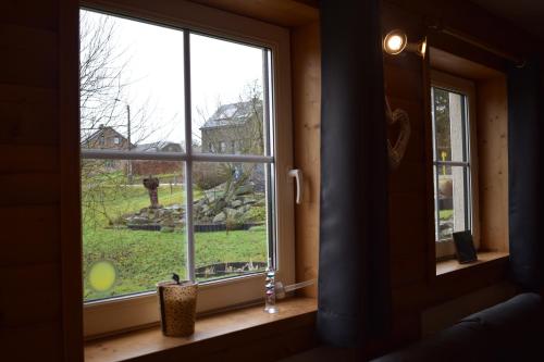 a window in a room with a view of a yard at Gîte du cheval blanc in Sainte-Ode