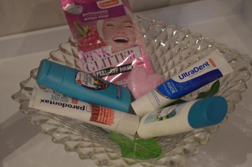 a basket filled with toothbrushes tooth paste and toothpaste at Gîte du cheval blanc in Sainte-Ode