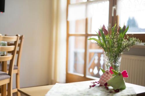 a vase filled with flowers sitting on a table at Haus Seidl in Bodenmais