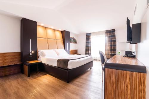 Ένα ή περισσότερα κρεβάτια σε δωμάτιο στο San Giorgio Palace Hotel Ragusa Ibla