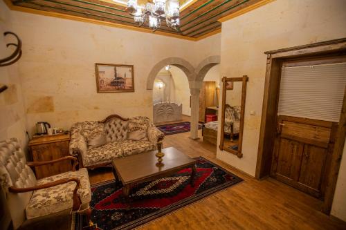 a living room with a couch and a table at Göreme Reva Hotel in Goreme