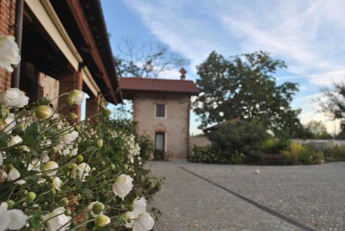 a building with white flowers in front of it at Agriturismo Tetto Garrone in Cuneo
