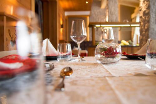 a group of wine glasses sitting on a table at Hotel Cristallo in Andalo