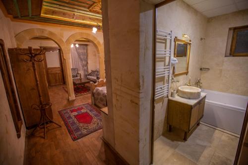 a bathroom with a sink and a bath tub at Göreme Reva Hotel in Goreme