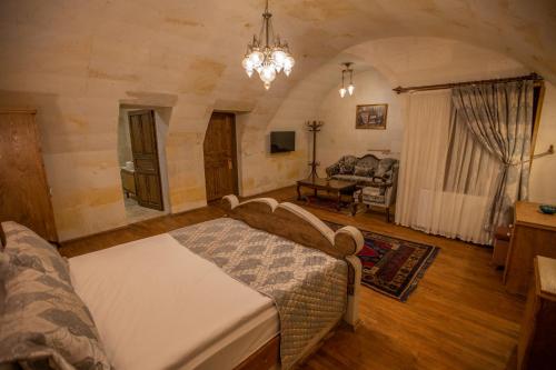 a bedroom with a bed and a living room at Göreme Reva Hotel in Goreme